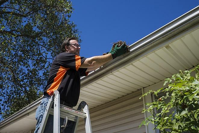 gutter being fixed by a maintenance person in Barren Springs